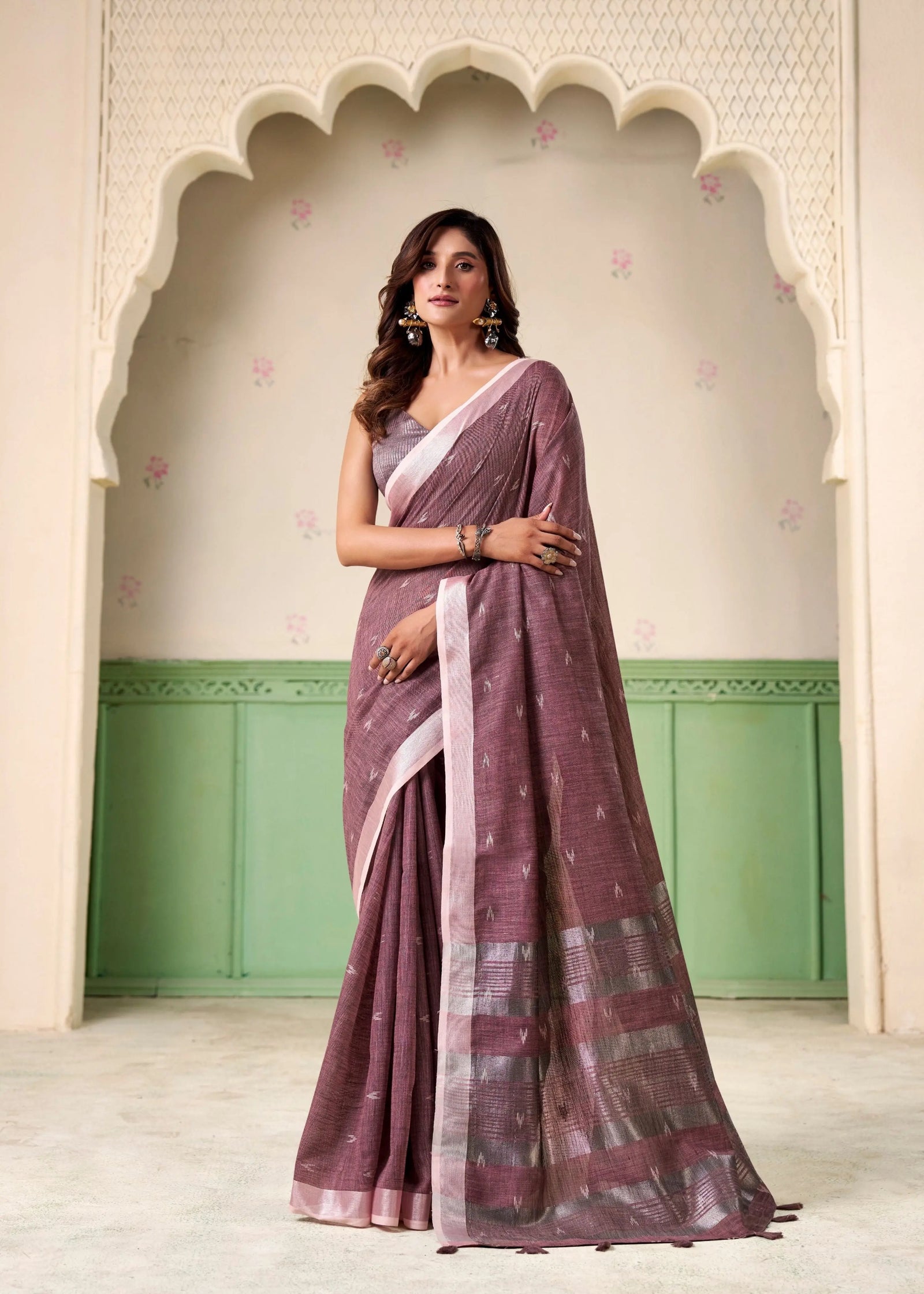 Woman wearing a traditional saree in a decorative setting