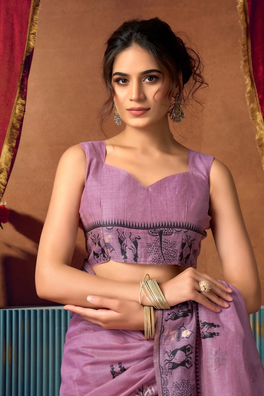 Woman wearing a purple saree with a brown background
