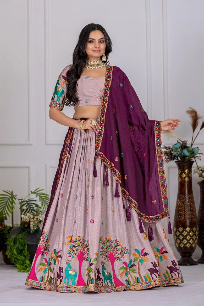 Woman wearing a traditional outfit with a purple dupatta in a well-lit room.