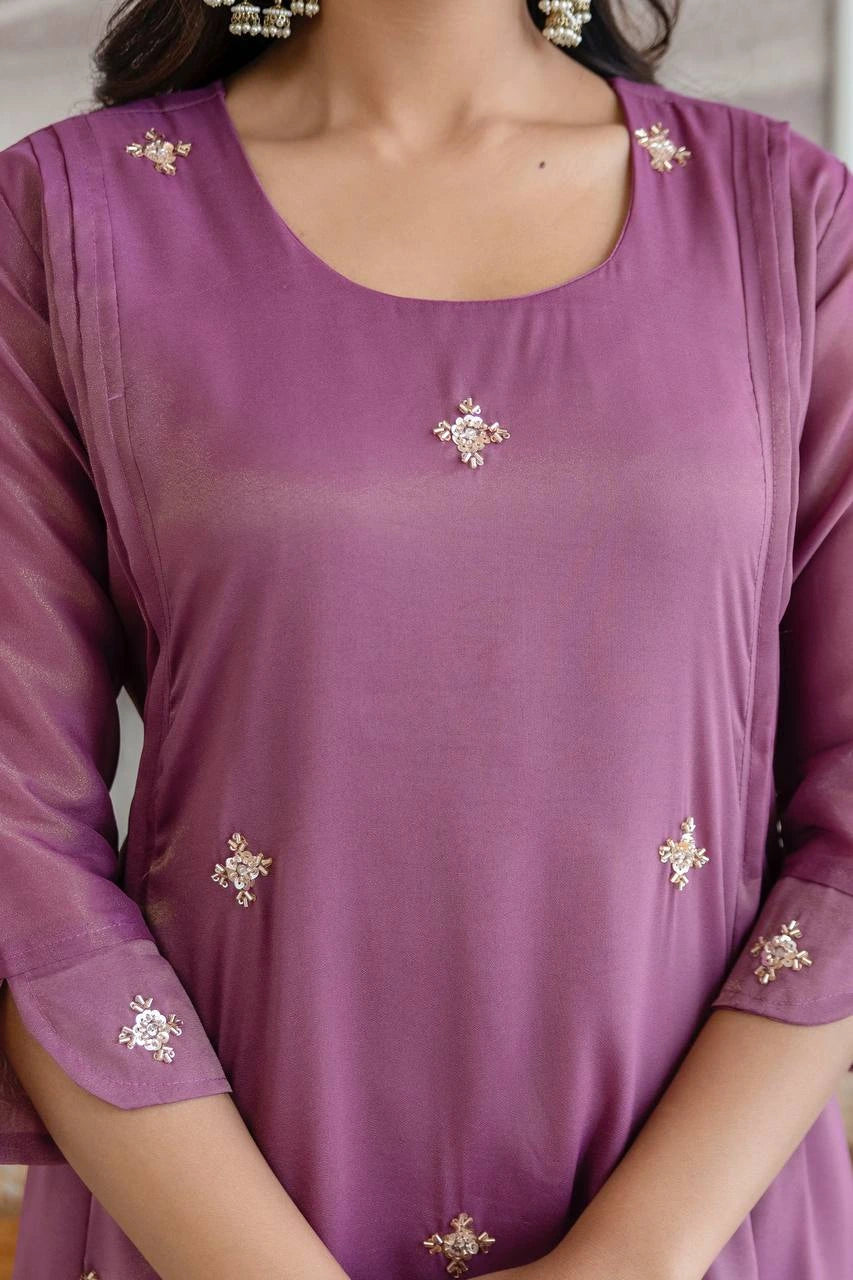 Purple top with decorative elements on a plain background
