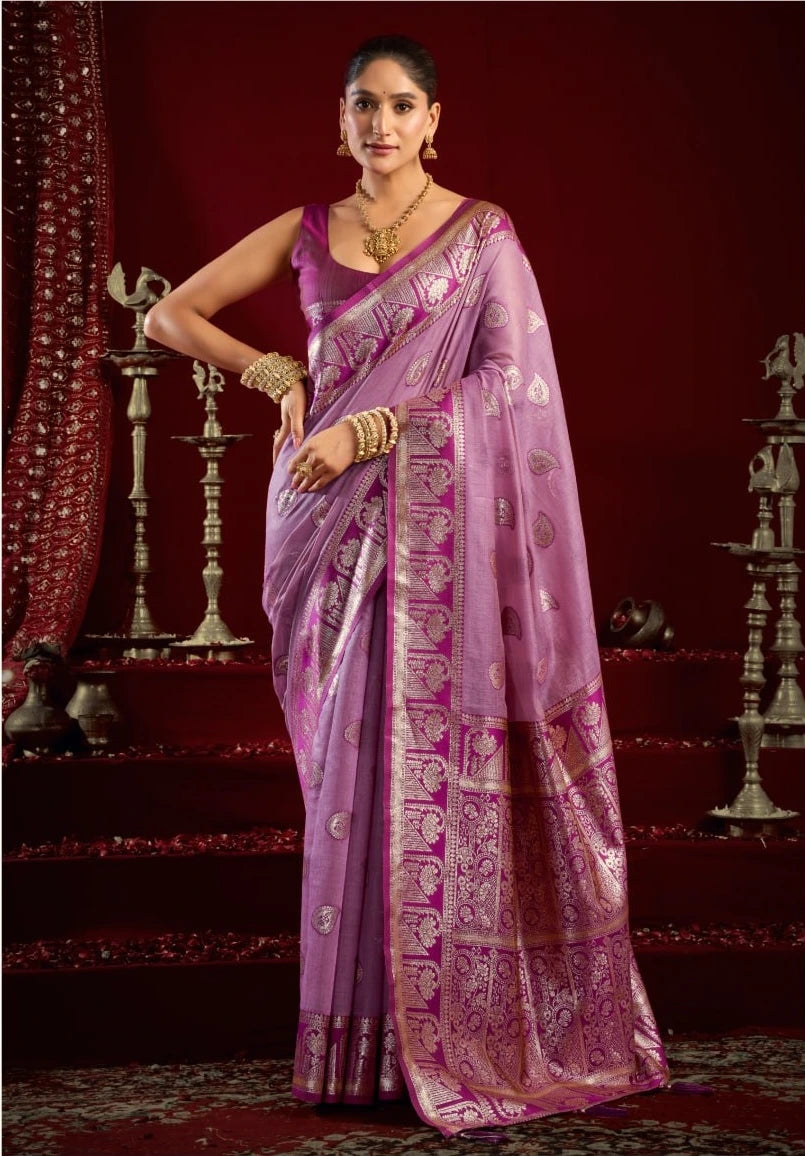 Woman wearing a traditional purple saree with a red background