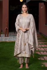 Woman in a traditional outfit standing outdoors on grass