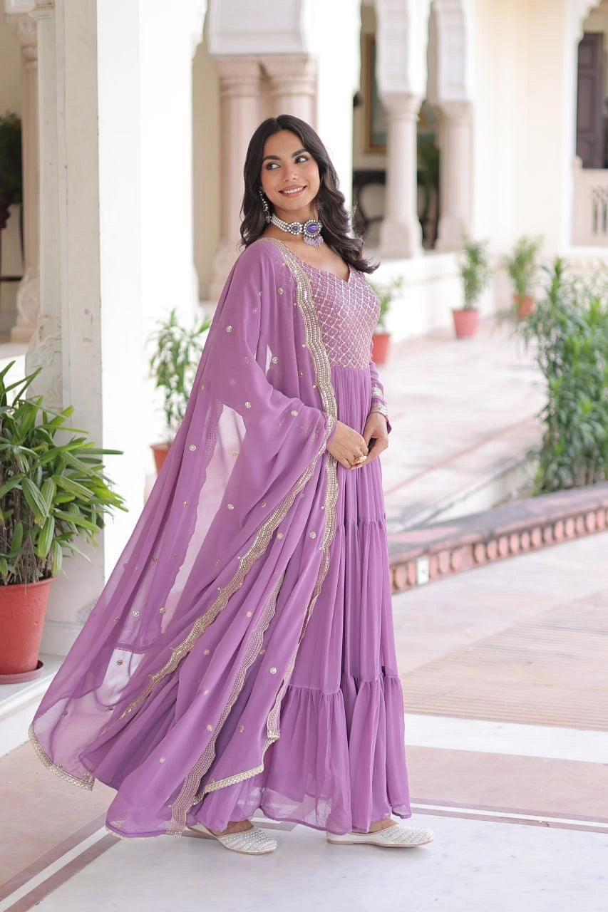 Woman wearing a purple saree with a white background