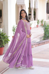 Woman wearing a purple saree with a white background