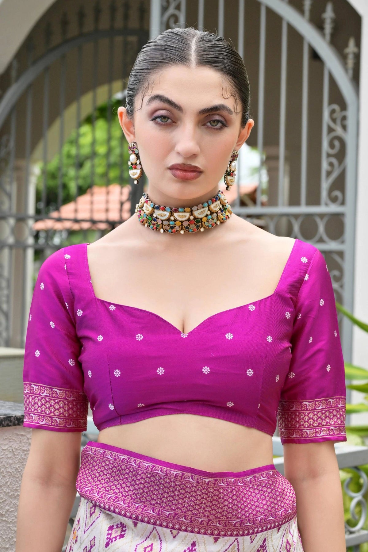 Traditional Banarasi silk saree in lavender pink with ornate zari patterns draped gracefully.