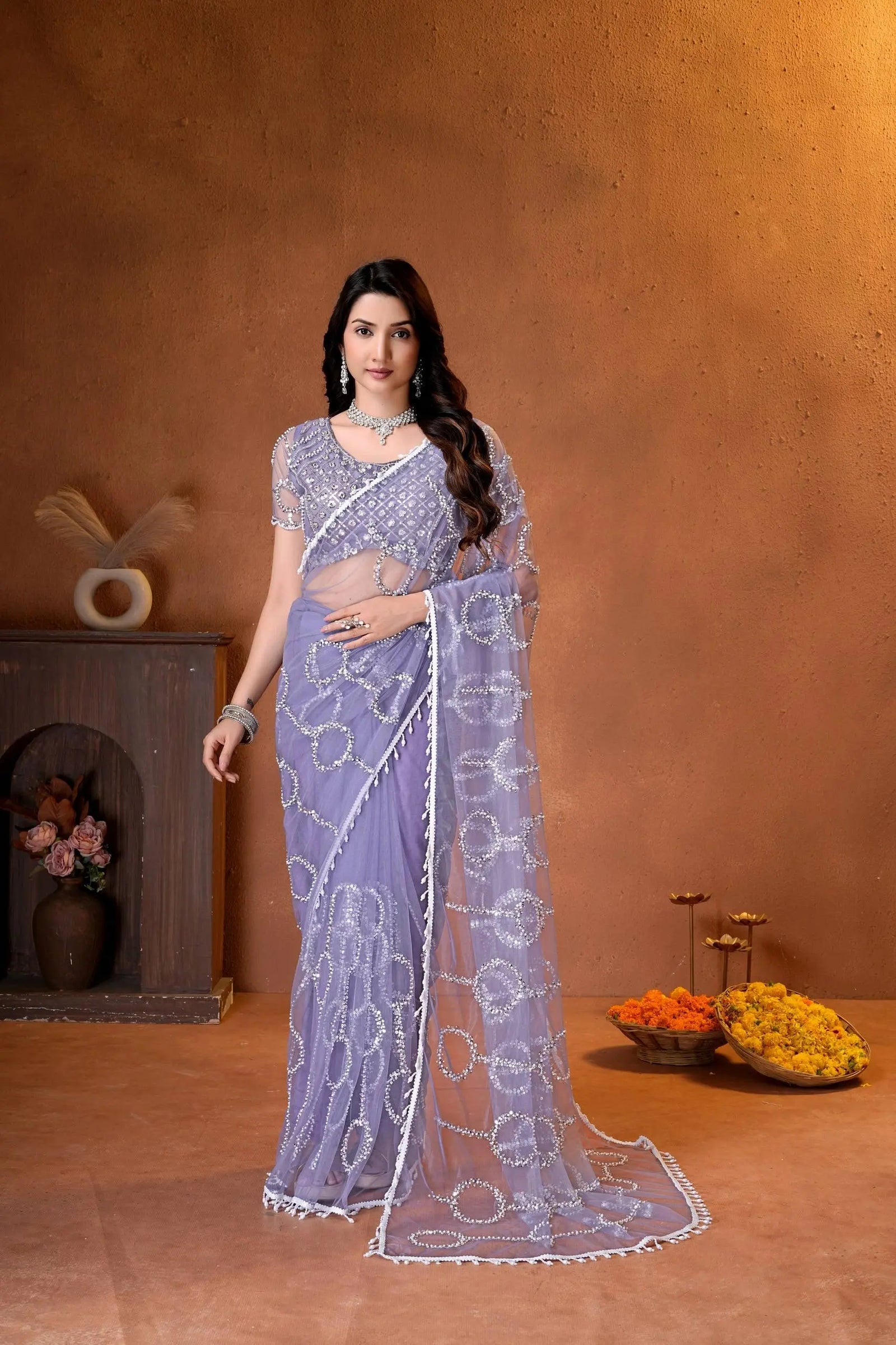 Elegant lavender designer saree featuring shimmering sequins embroidery and intricate handcrafted detailing for a graceful festive look.
