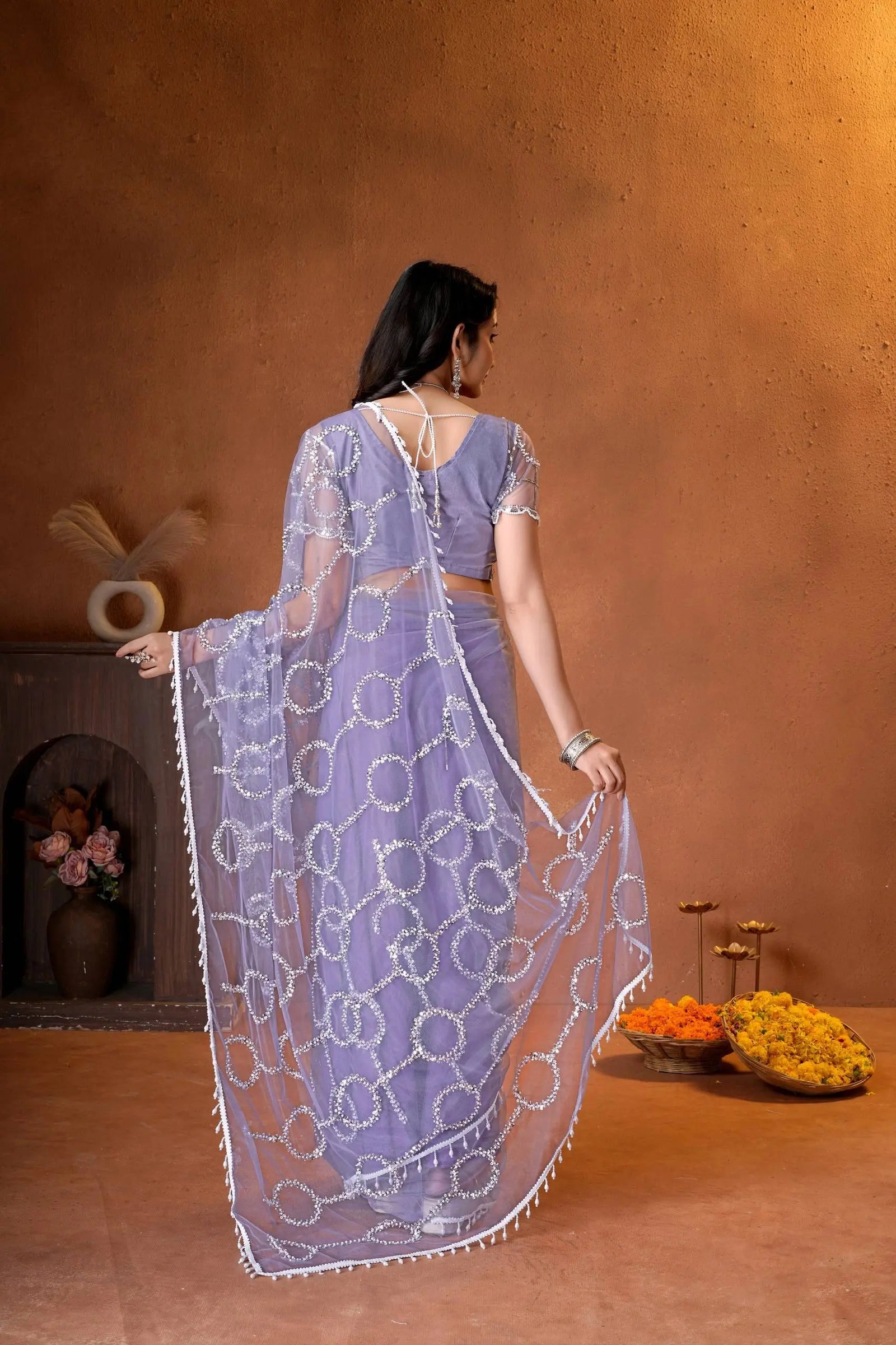 Stunning ethnic saree showcasing all-over sequins embellishments, stylish short sleeves, and luxurious traditional craftsmanship.