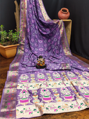 Purple and white patterned fabric with a small statue on a wooden platform.