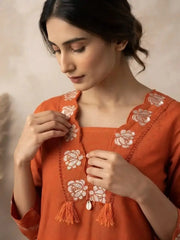 Floral embroidery and tassel detail on V-neck of Light Orange Embroidered Kurti