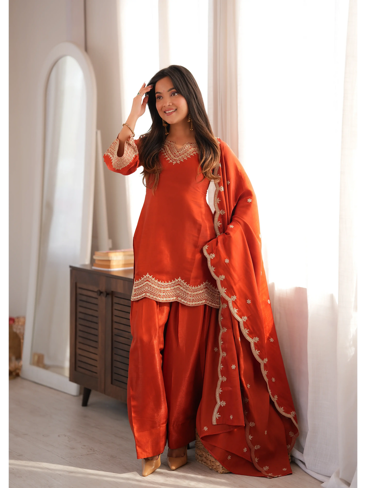 Light Orange Sequins Suit with dupatta draped over shoulder