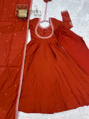 Flat lay of complete Light Orange Thread Work Anarkali Suit set with pant and dupatta