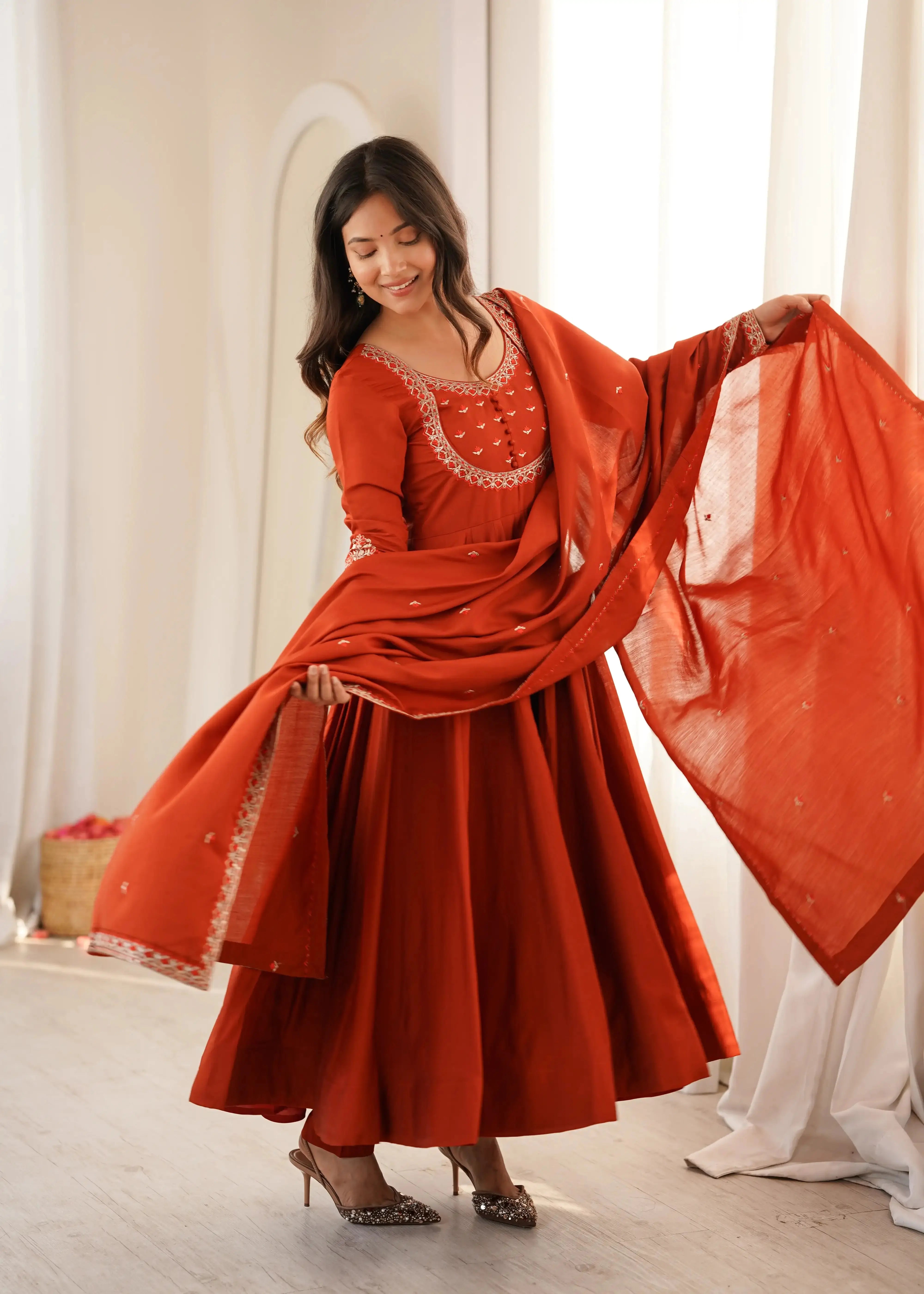 Light Orange Thread Work Anarkali Suit front view model holding dupatta