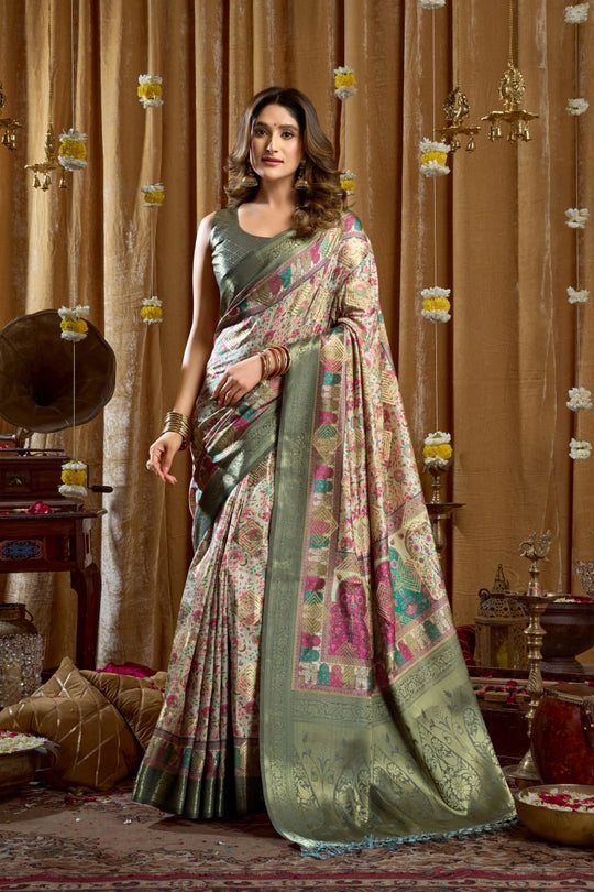 Woman wearing a traditional saree in a decorated room with ornate curtains and decor.
