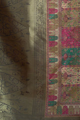 Textile with intricate patterns and designs on a green background