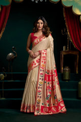 Woman wearing a traditional saree with floral patterns in a decorative setting.