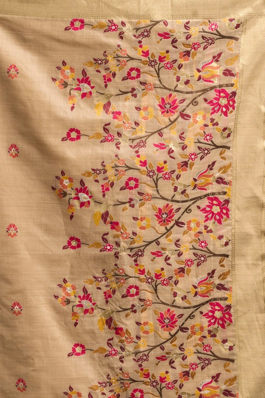 Beige fabric with floral embroidery in pink, red, and yellow on a beige background