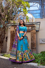 Premium sky blue ethnic saree with Kalamkari artwork, purple floral pallu, and graceful traditional style.