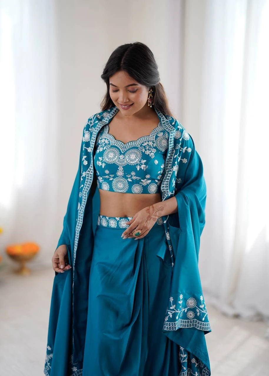 Woman wearing a traditional blue embroidered outfit with a white background