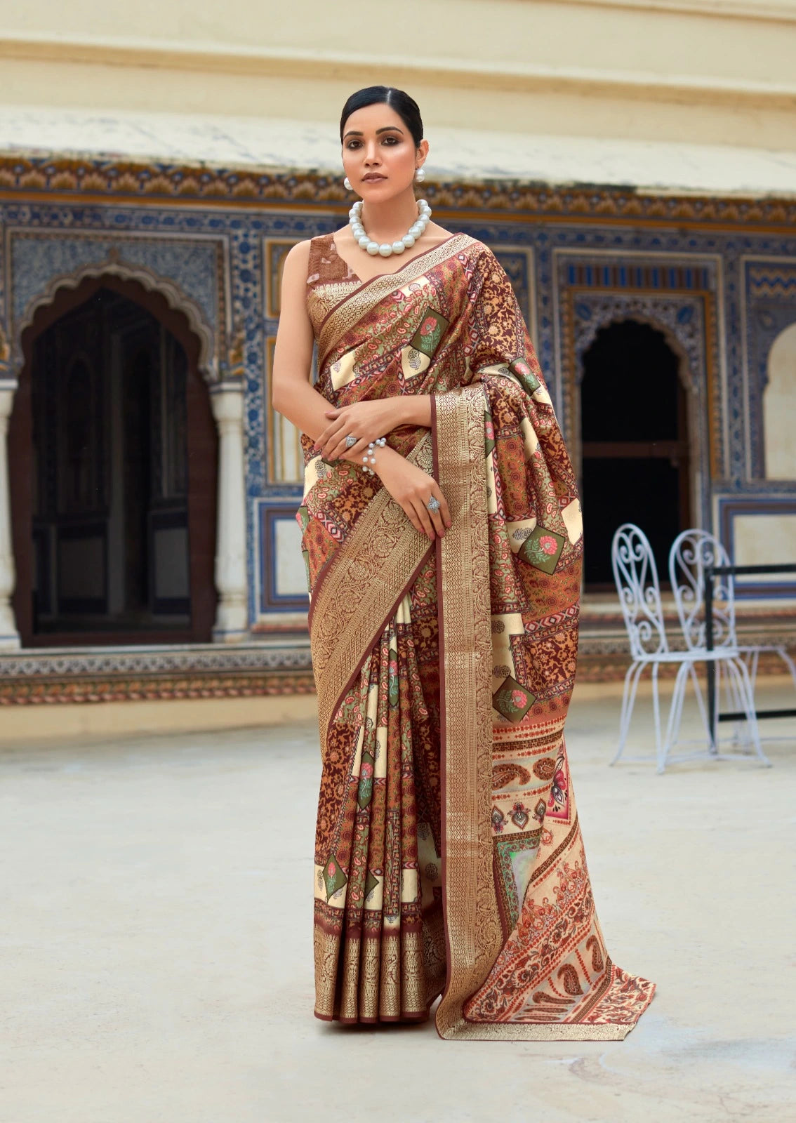 Woman wearing a traditional saree in an ornate indoor setting