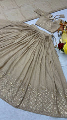 Beige saree with intricate patterns on a light gray surface
