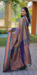 Woman in a traditional saree standing outdoors with a blurred background