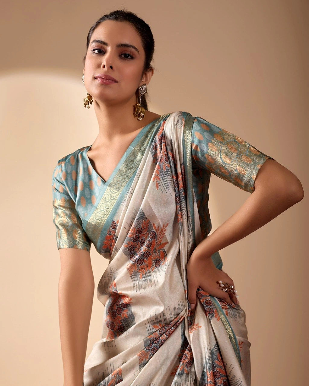 Woman wearing a traditional saree with a neutral background