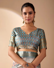 Woman wearing a patterned blouse against a beige background