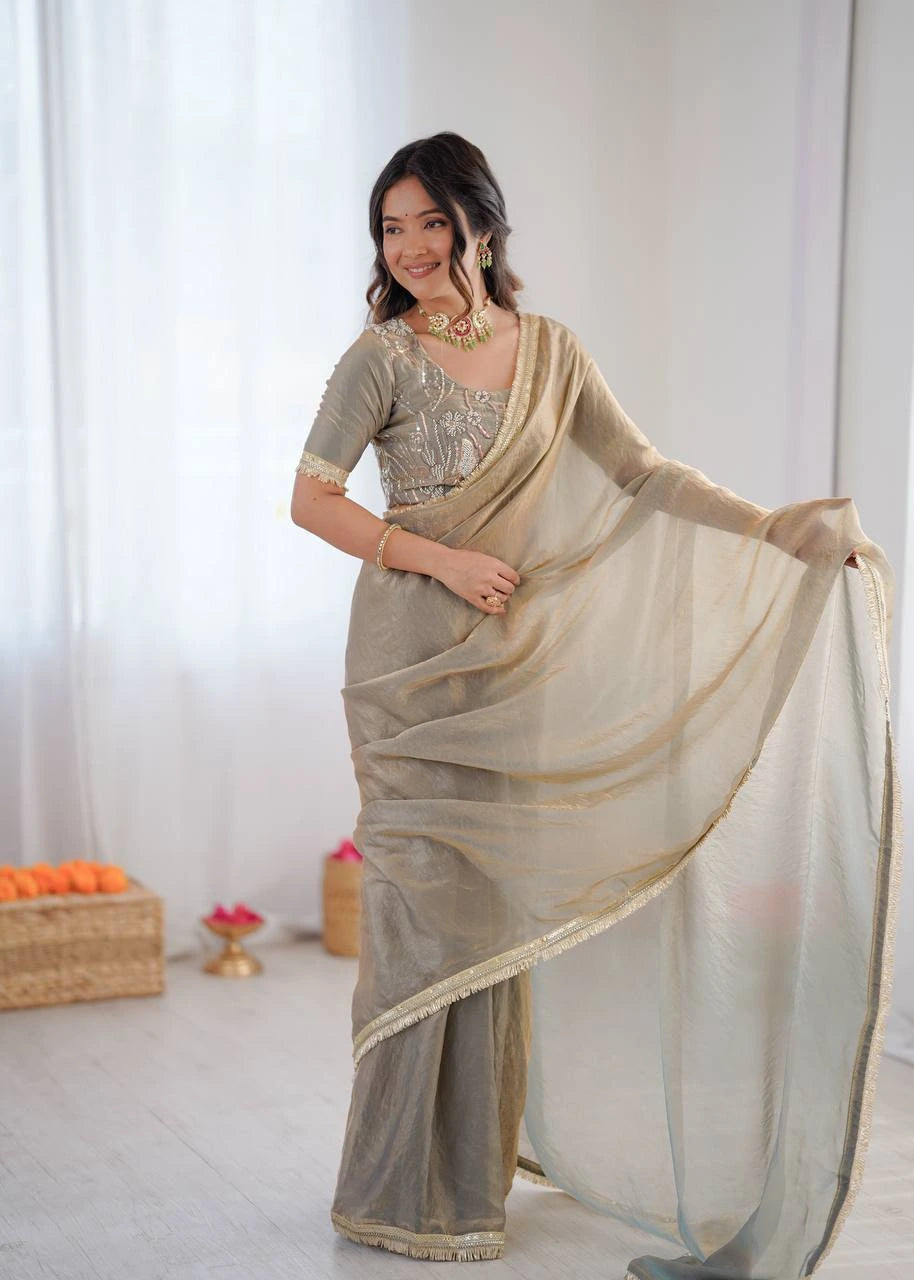Woman wearing a beige saree with a white background