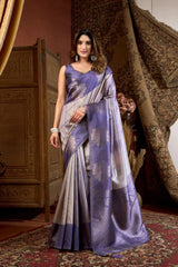 Woman wearing a purple and gray saree in an ornate room.