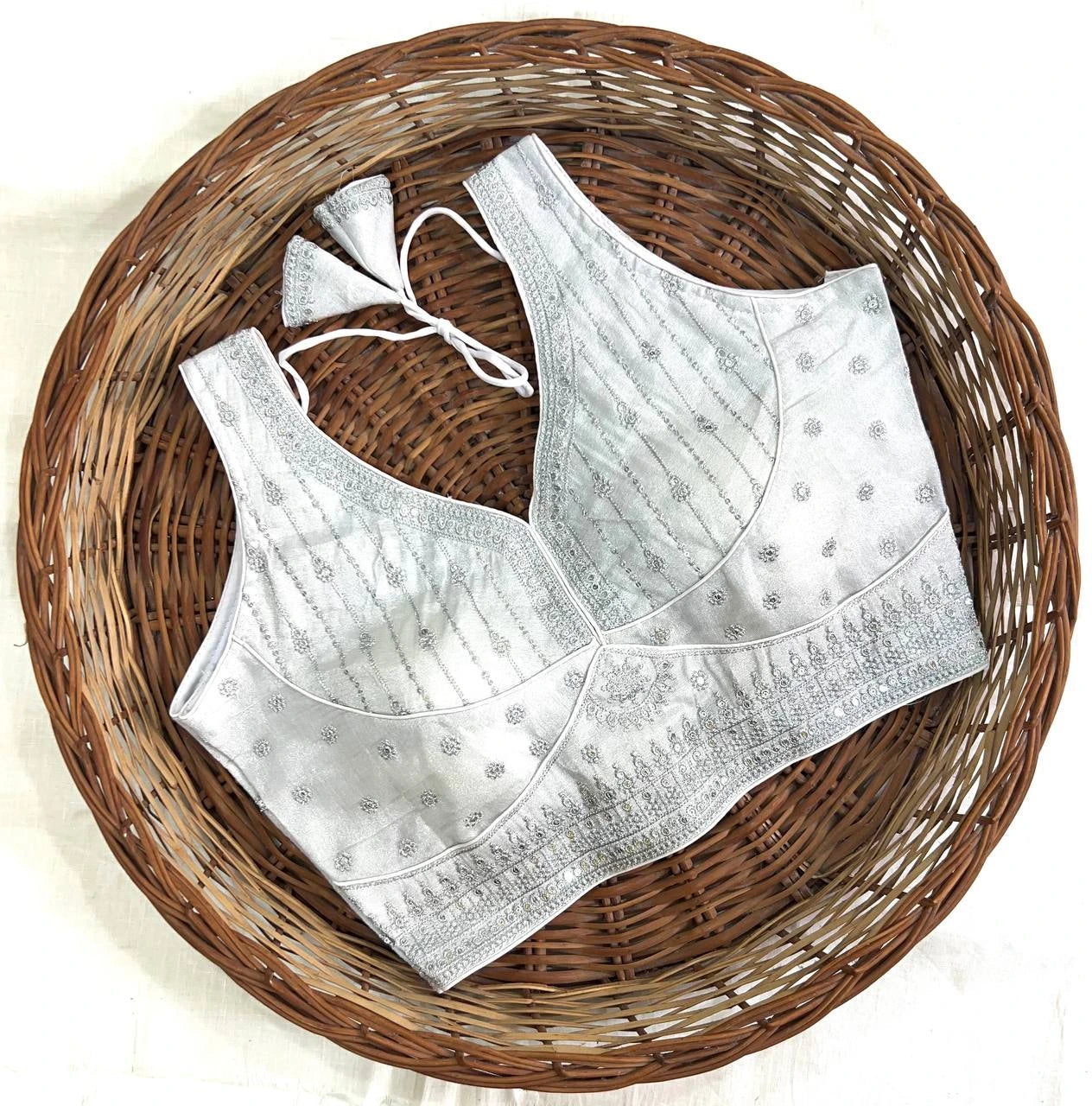 White embroidered bralette on a woven basket