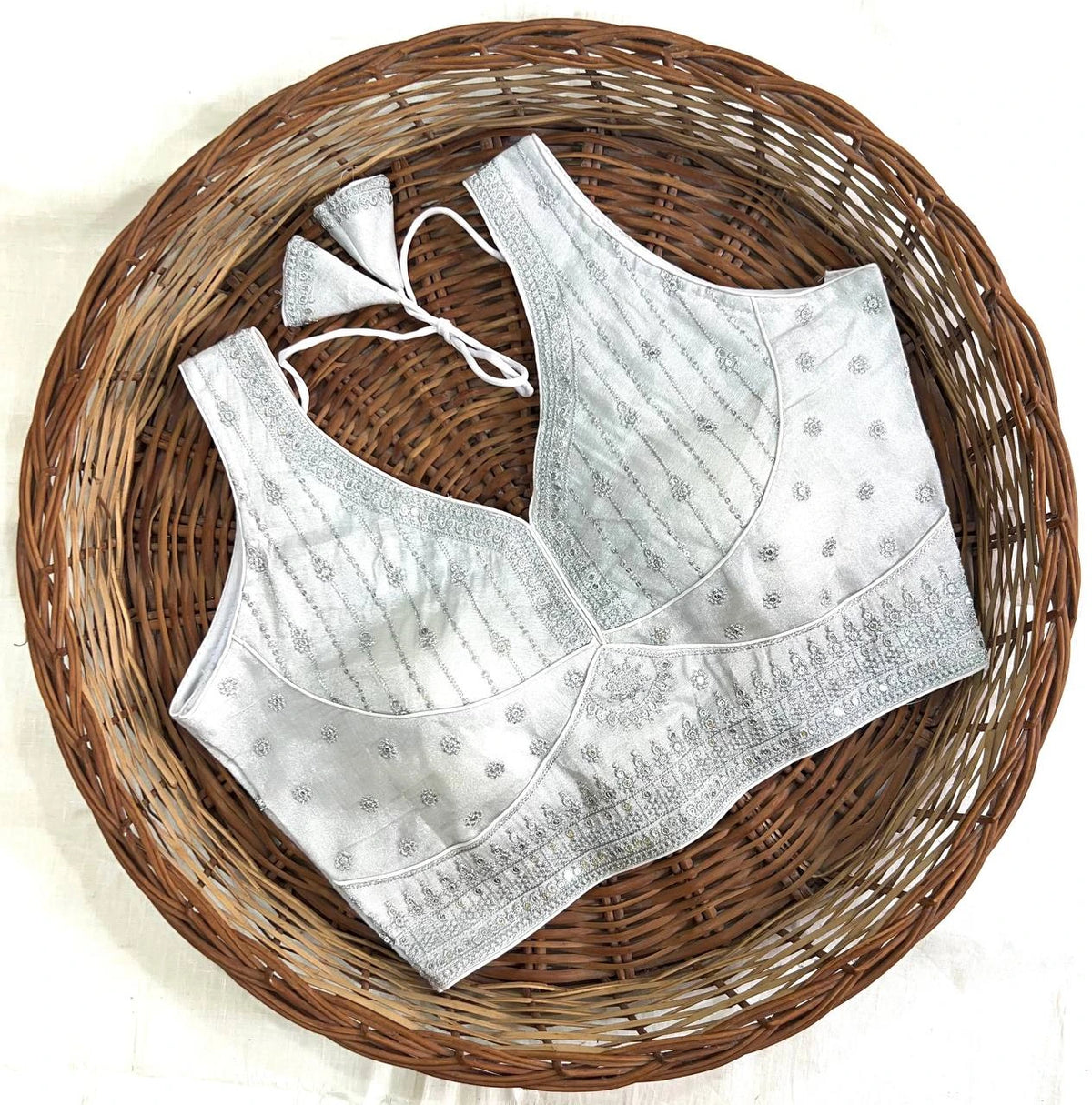 White embroidered bralette on a woven basket