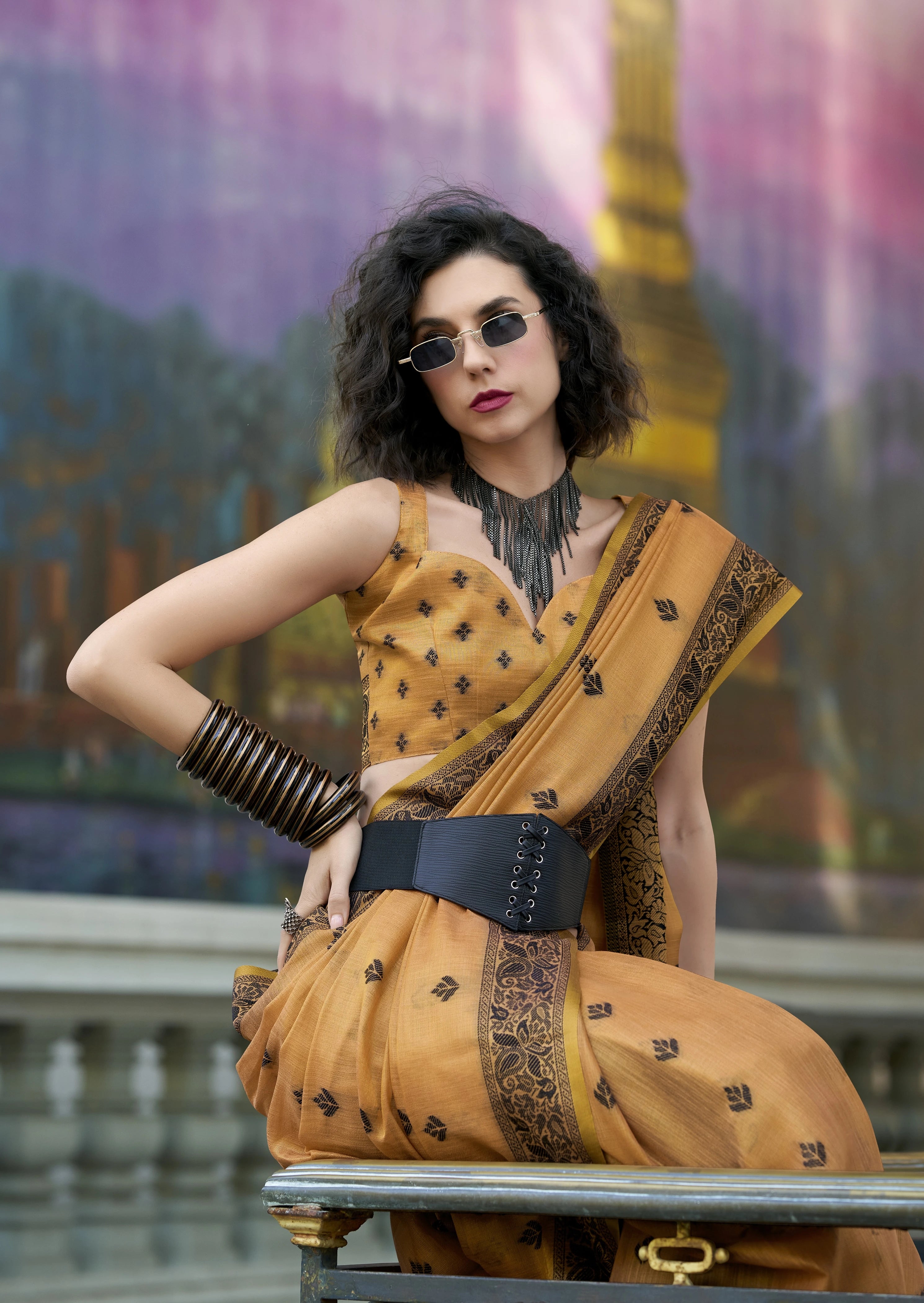 Woman in a yellow saree with a blurred background