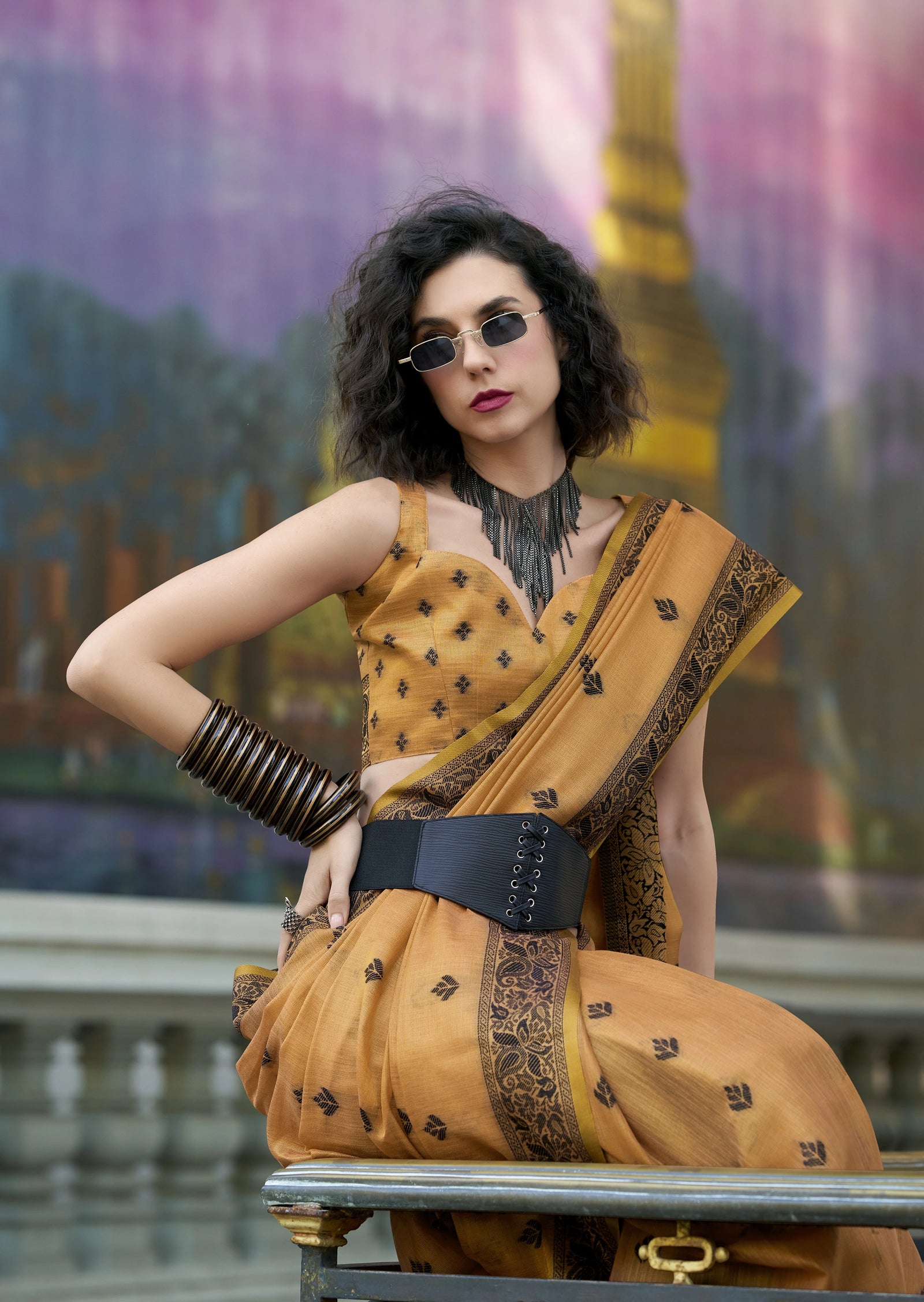 Woman in a yellow saree with a blurred background
