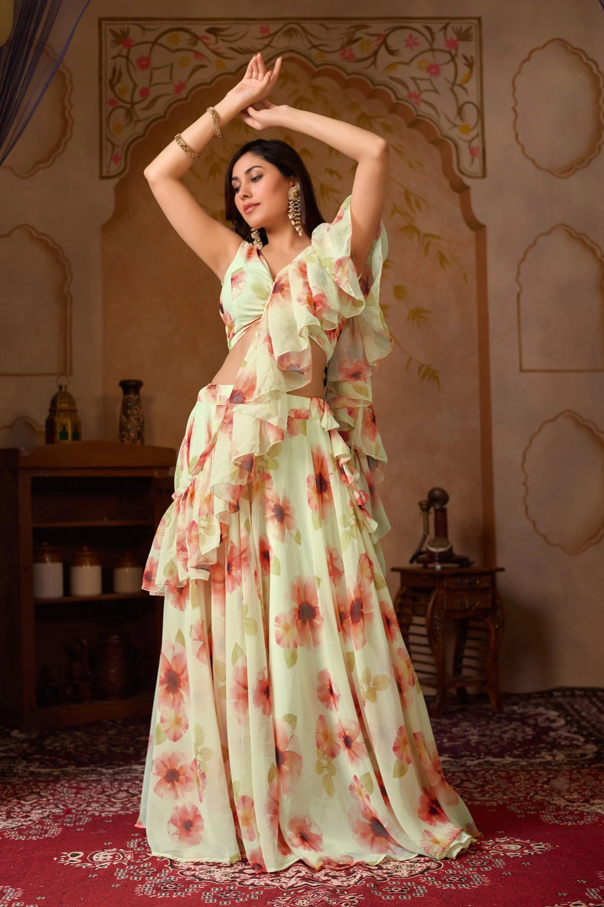 Woman in a floral dress posing in a decorated room.