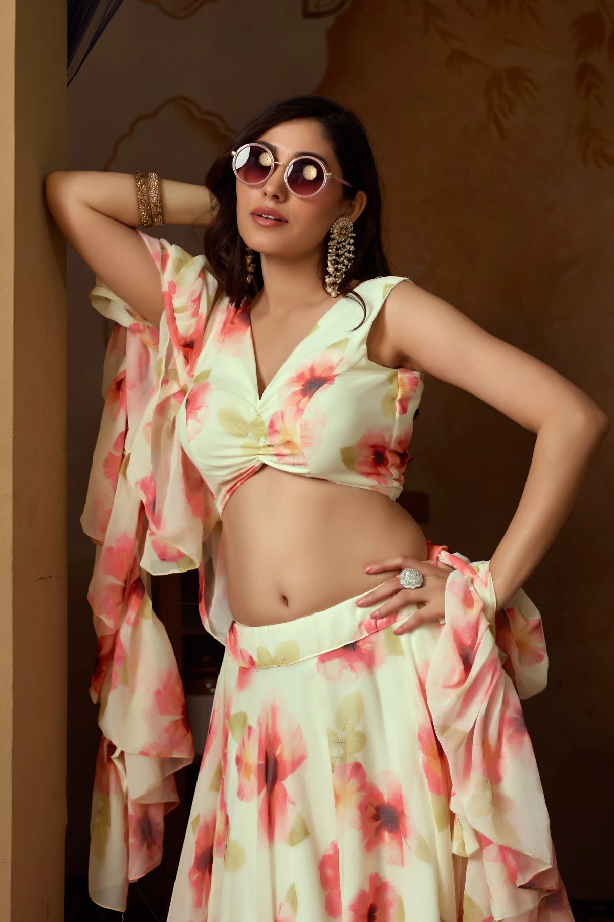 Woman wearing a floral outfit with sunglasses indoors