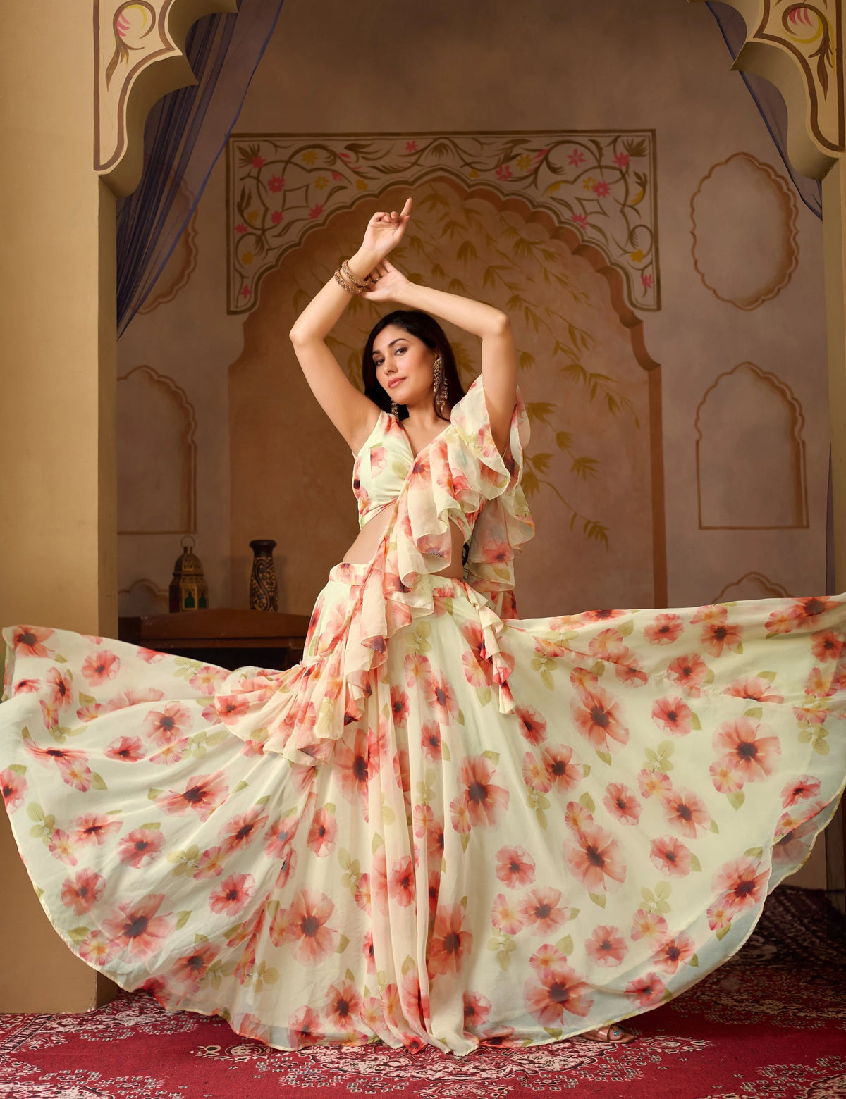 Woman in a floral dress posing in an ornate room.