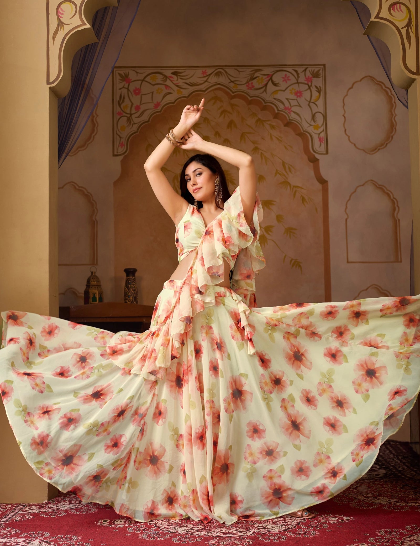 Woman in a floral dress posing in an ornate room.