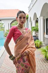 Woman in a traditional saree standing outdoors near a pool