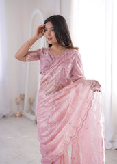 Woman wearing a pink saree with a white background