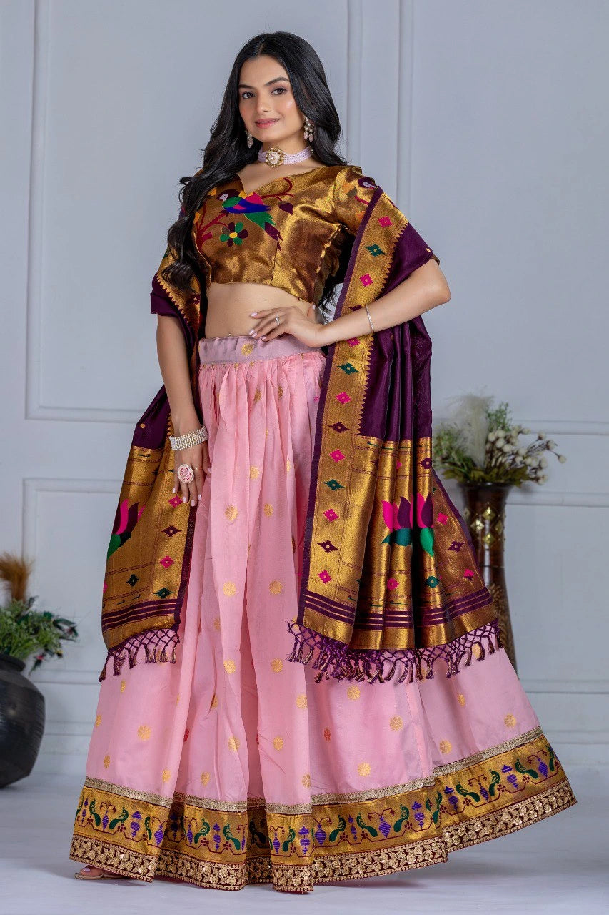 Woman wearing a traditional outfit with a pink skirt and gold blouse against a white background