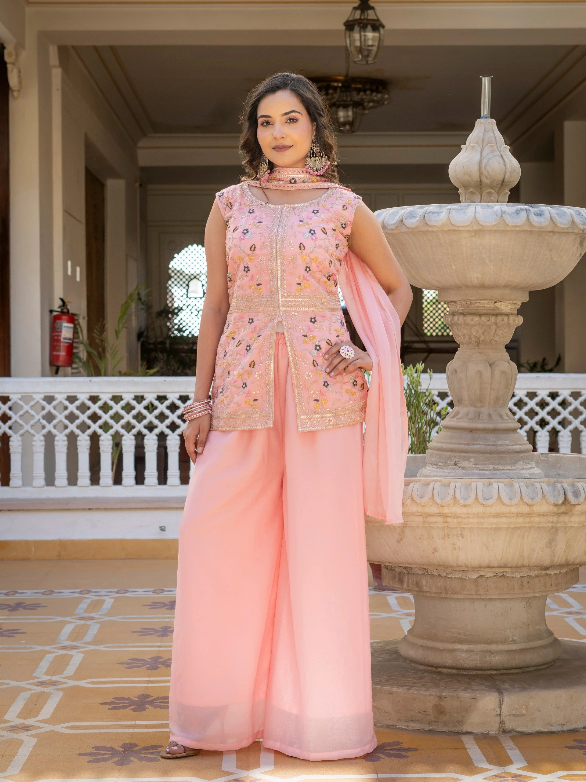 Light pink georgette suit with heavy embroidery displayed on mannequin.