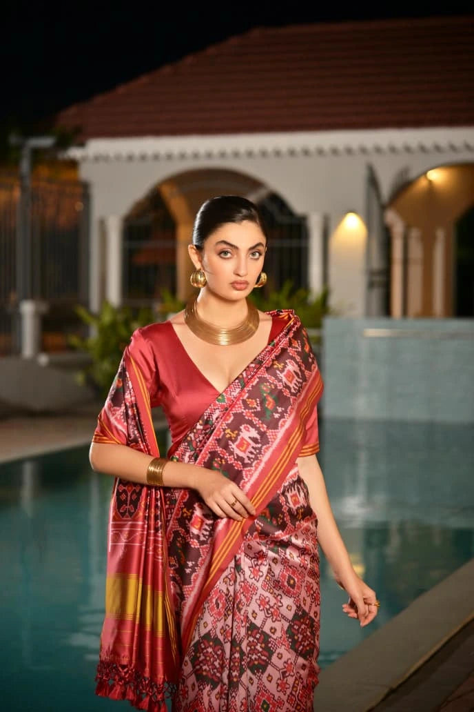 Traditional Indian silk saree in light pink with intricate Ikkat patterns showcased online