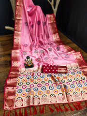 Pink saree with intricate patterns on a wooden surface