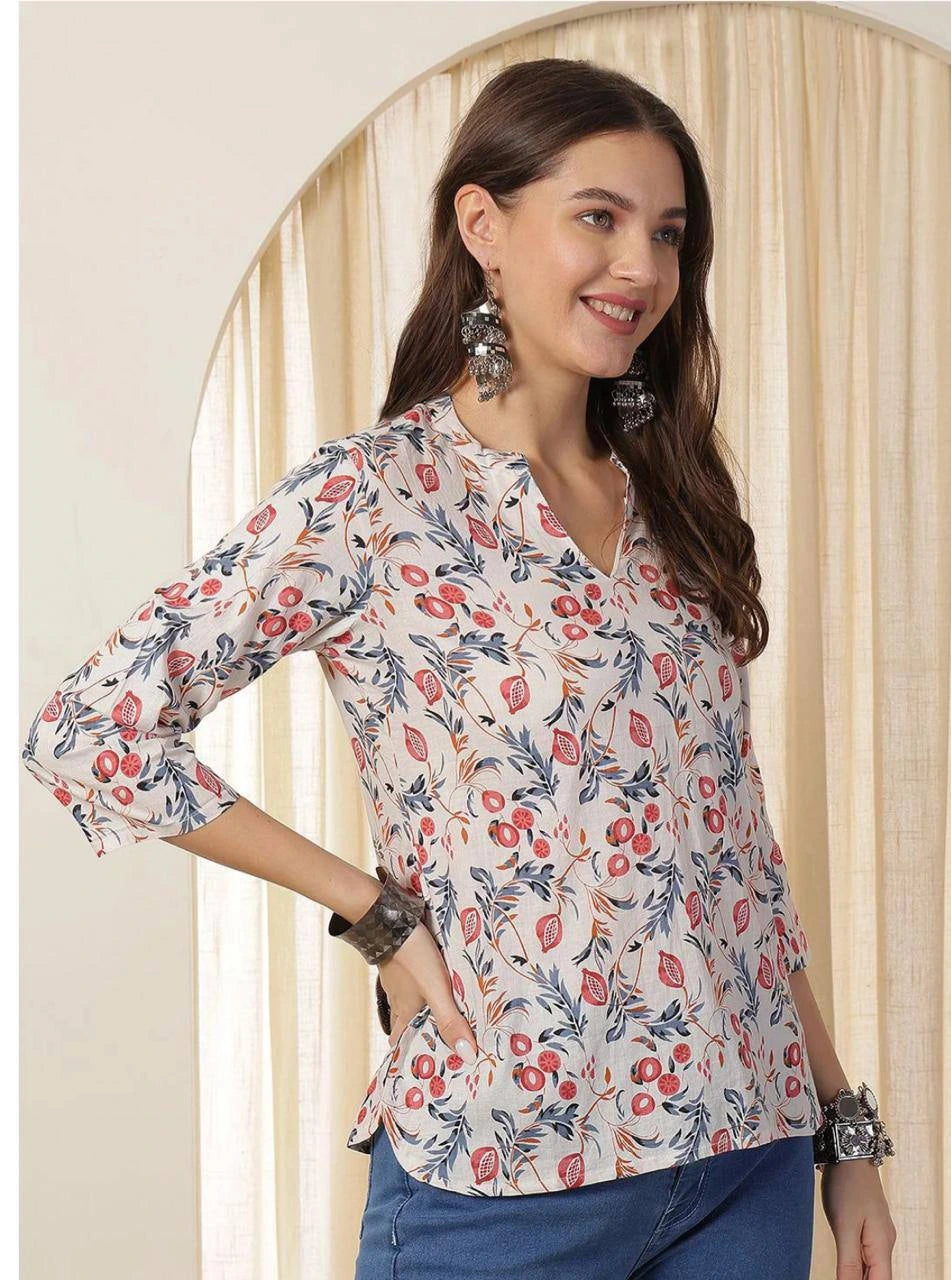 Woman wearing a floral blouse with a neutral background