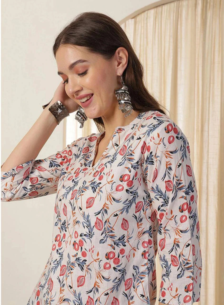 Woman wearing a floral blouse with a neutral background