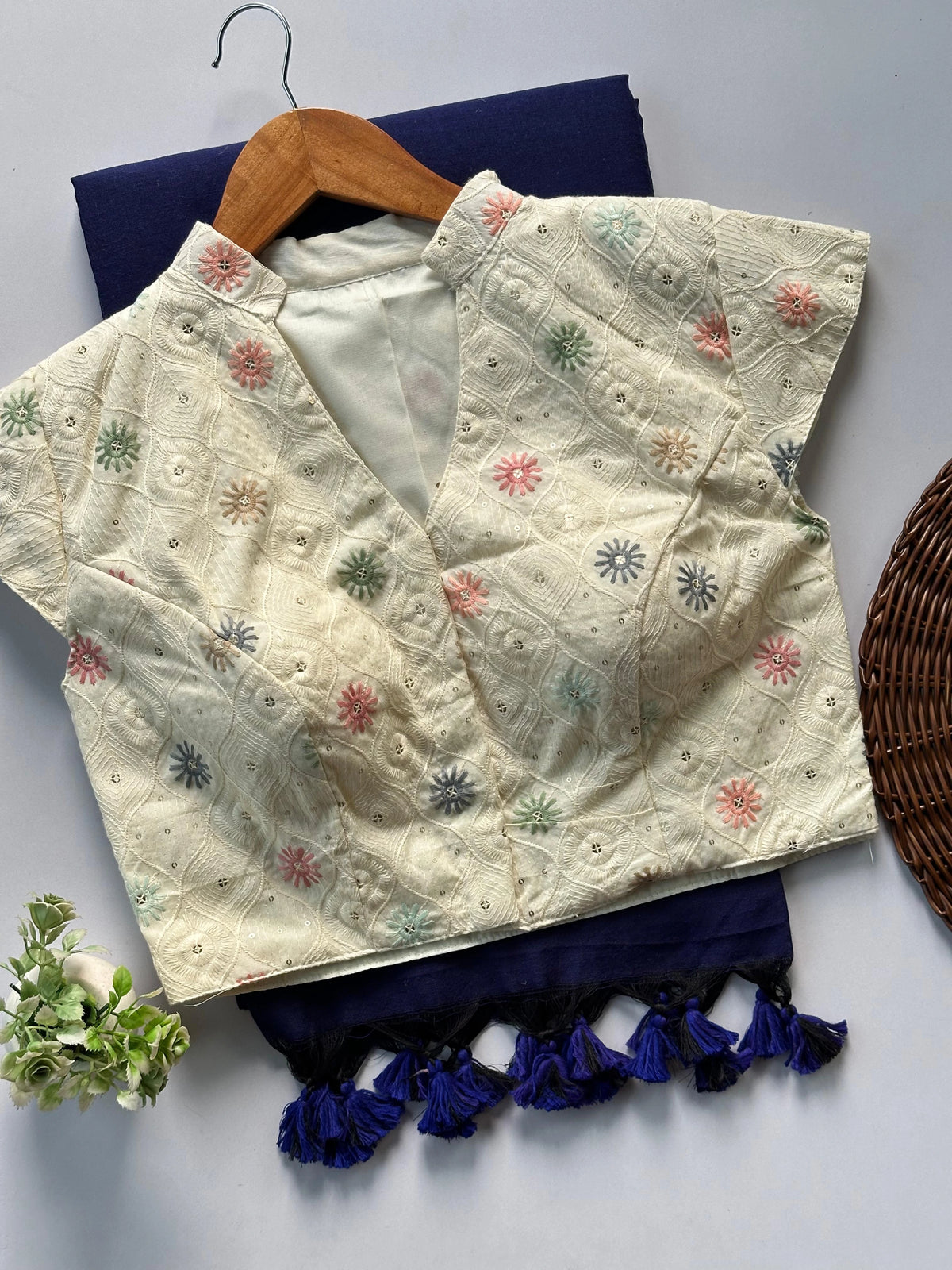 Embroidered blouse with colorful patterns on a white surface