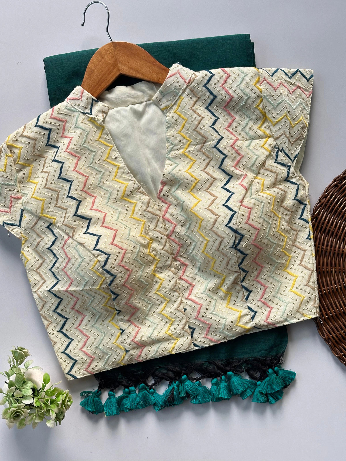 Textile with zigzag pattern on a hanger against a neutral background