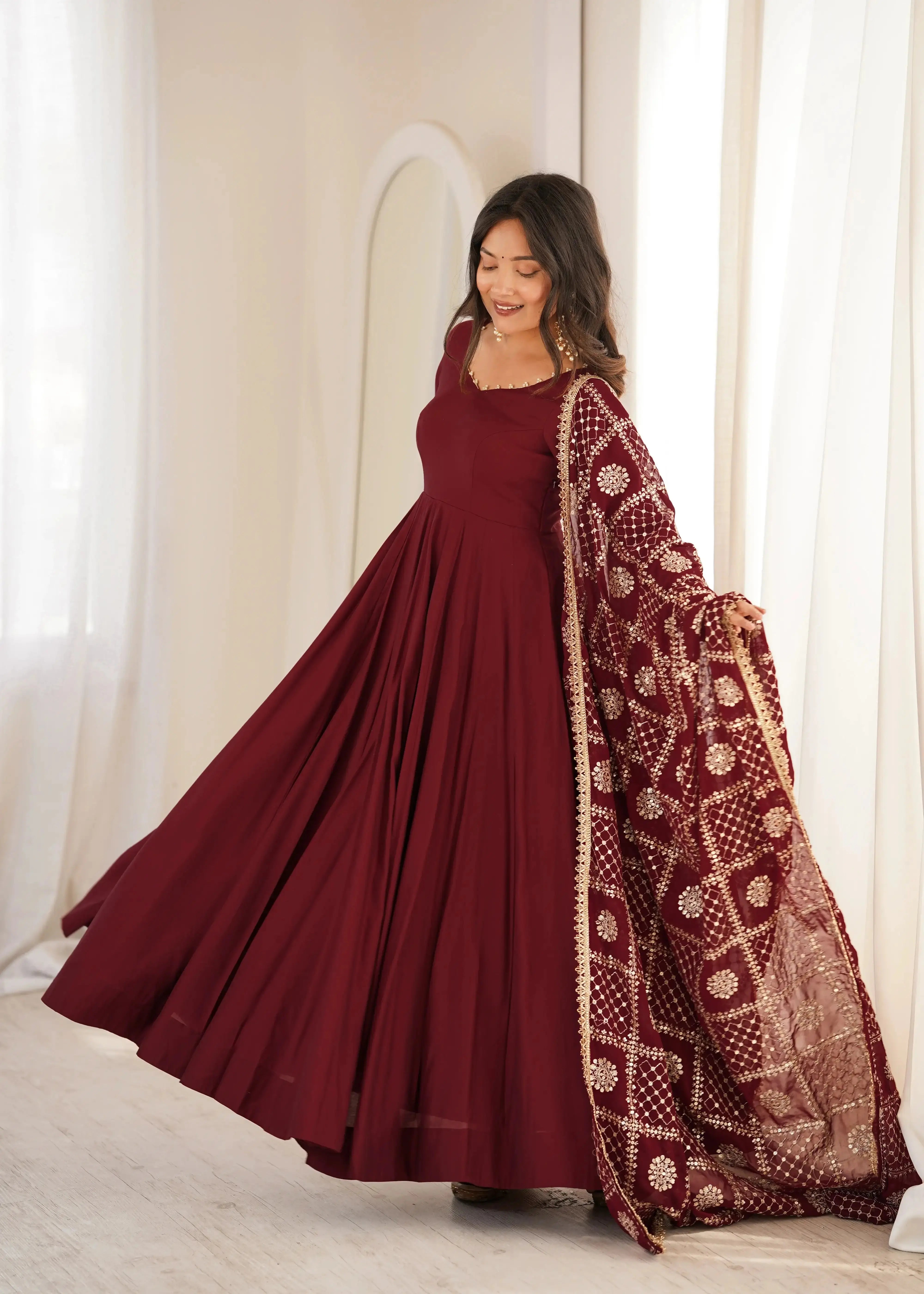 Maroon Sequins Embroidered Anarkali Suit dynamic side pose showing Anarkali sweep