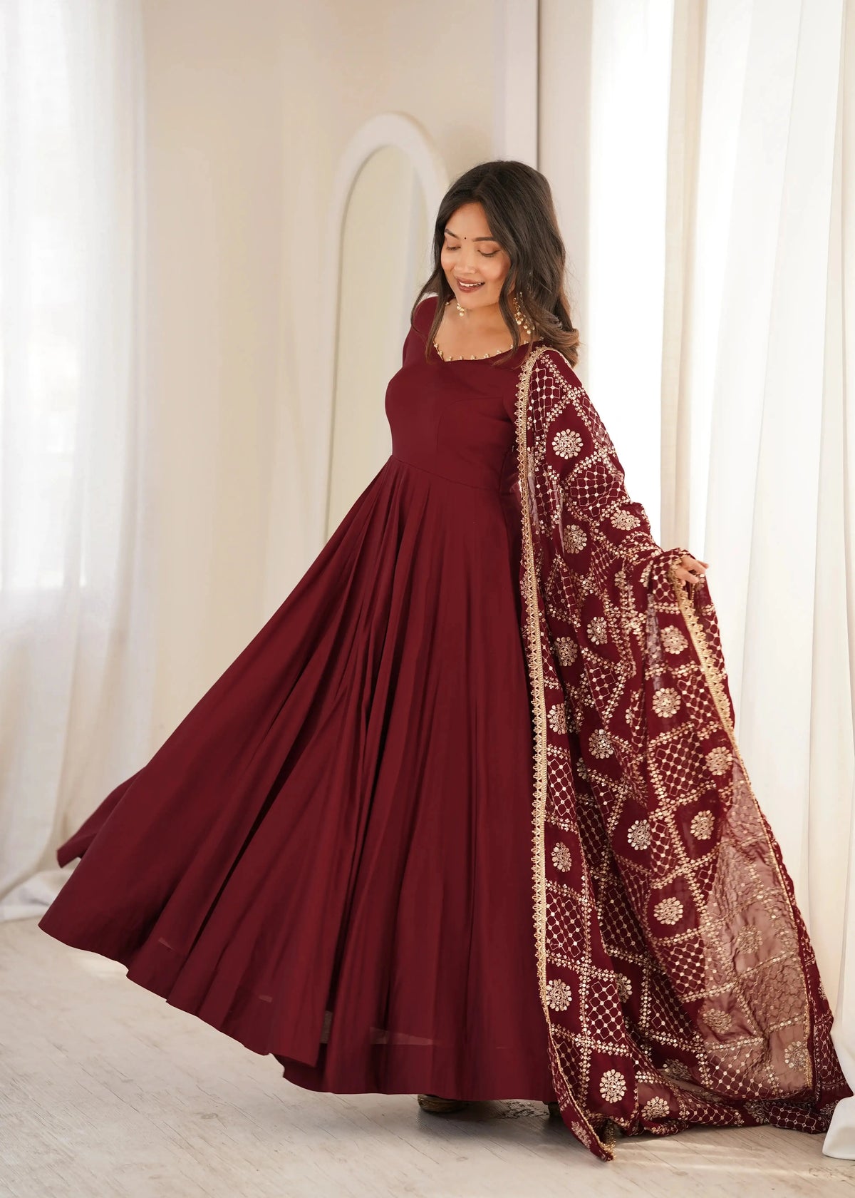 Maroon Sequins Embroidered Anarkali Suit dynamic side pose showing Anarkali sweep