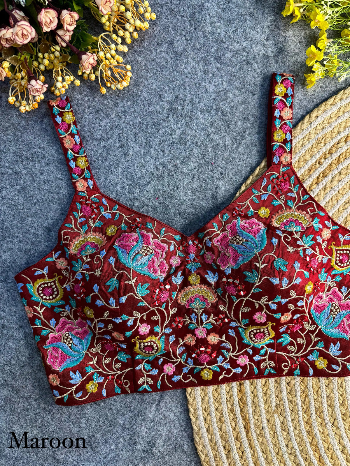 Elegant maroon silk blouse featuring intricate embroidery and delicate sequin work, perfect for festive and traditional occasions